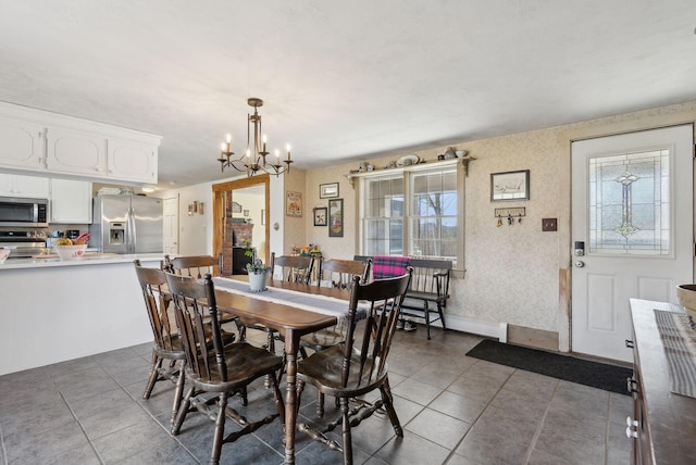 205 Patterson Rd, Limerick, ME 04048 - dining area featuring tile patterned floors, a chandelier, and wallpapered walls