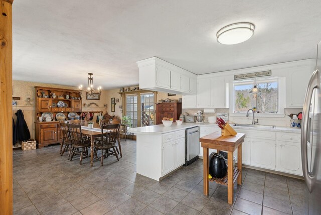 205 Patterson Rd, Limerick, ME 04048 - kitchen featuring white cabinets, a sink, light countertops, a peninsula, and stainless steel appliances