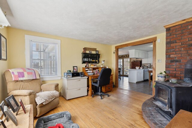 205 Patterson Rd, Limerick, ME 04048 - office area featuring a wood stove and light wood-type flooring