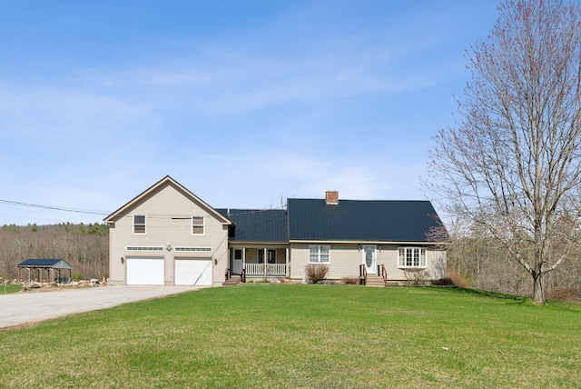 205 Patterson Rd, Limerick, ME 04048 - view of front of house featuring covered porch, driveway, a chimney, a front yard, and an attached garage