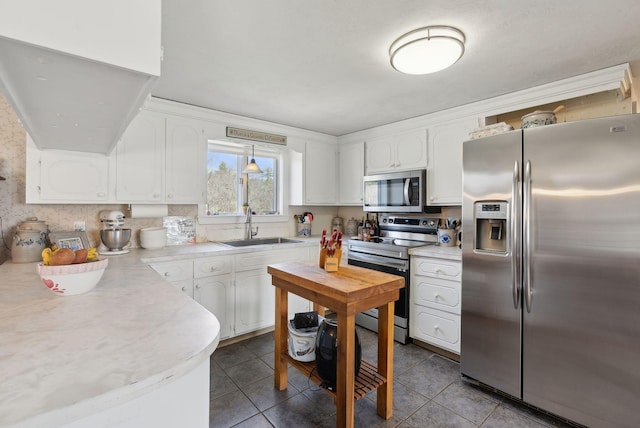 205 Patterson Rd, Limerick, ME 04048 - kitchen with light countertops, a sink, white cabinetry, and stainless steel appliances