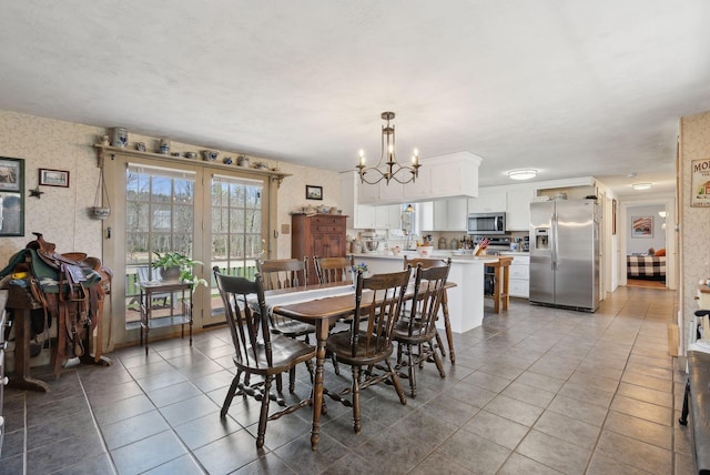 205 Patterson Rd, Limerick, ME 04048 - dining area with light tile patterned floors, wallpapered walls, and a chandelier