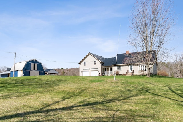 205 Patterson Rd, Limerick, ME 04048 - rear view of house featuring an attached garage, a gambrel roof, a lawn, and a chimney