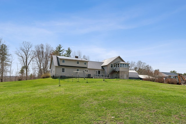 205 Patterson Rd, Limerick, ME 04048 - back of house with a lawn, metal roof, and a chimney