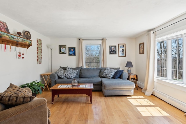 205 Patterson Rd, Limerick, ME 04048 - living area with a baseboard radiator, a wealth of natural light, and light wood-type flooring