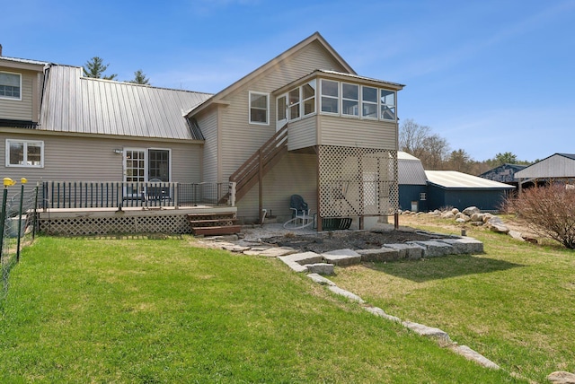 205 Patterson Rd, Limerick, ME 04048 - back of house with a sunroom, a lawn, a deck, and metal roof