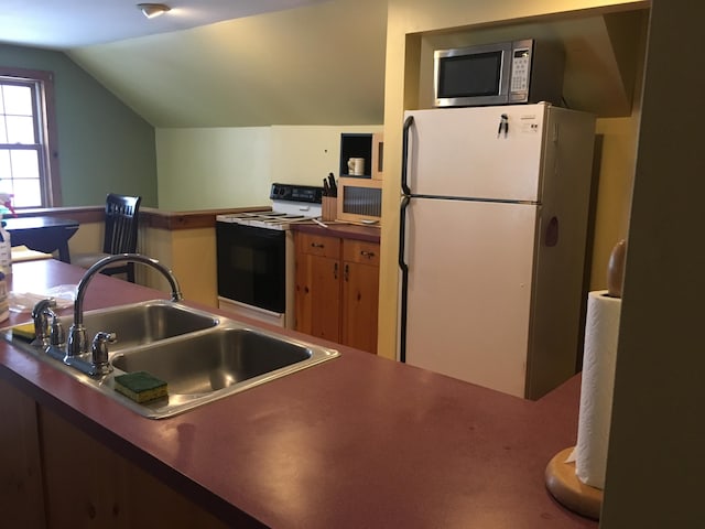 205 Patterson Rd, Limerick, ME 04048 - kitchen featuring range with electric stovetop, a sink, stainless steel microwave, freestanding refrigerator, and lofted ceiling