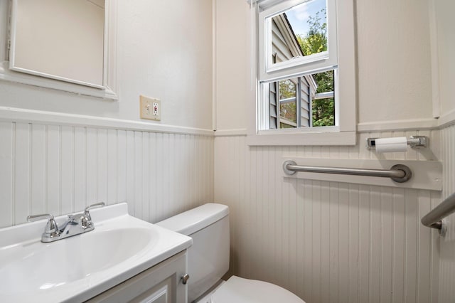 518 Ossipee Trl E, Gorham, ME 04038 - bathroom with a wainscoted wall, toilet, and vanity