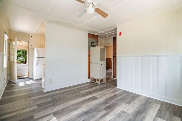 518 Ossipee Trl E, Gorham, ME 04038 - spare room featuring a ceiling fan, a decorative wall, wood finished floors, a heating unit, and wainscoting