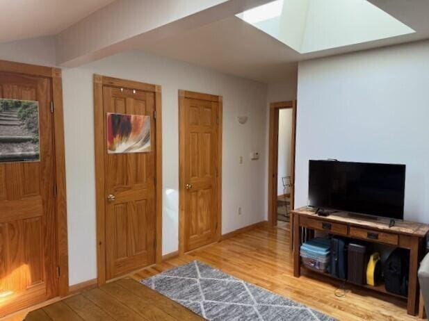entryway featuring baseboards and wood finished floors