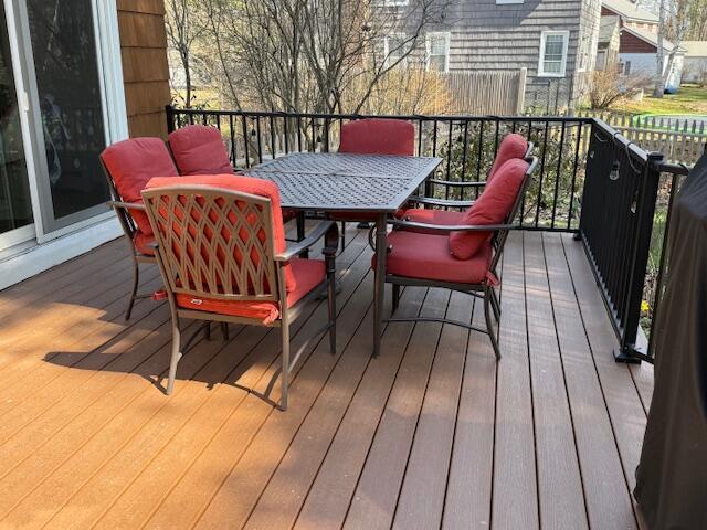 wooden terrace featuring outdoor dining area
