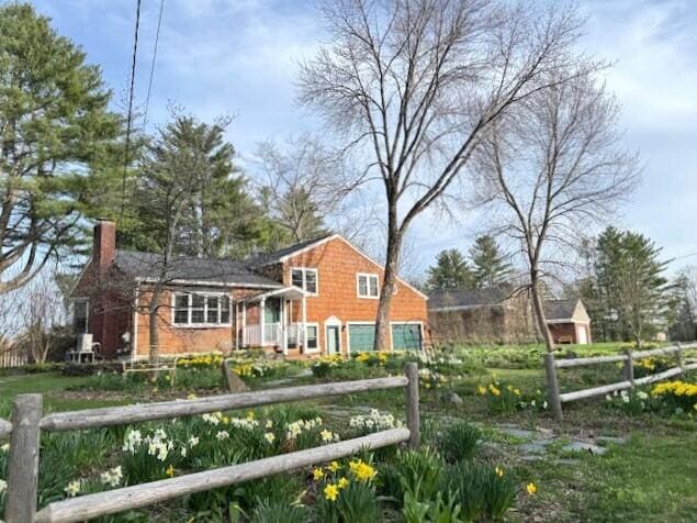 view of front of house with fence and a chimney