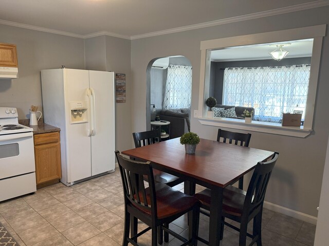 47 New Jersey St, Millinocket, ME 04462 - dining area featuring crown molding, arched walkways, and light tile patterned floors