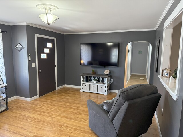 47 New Jersey St, Millinocket, ME 04462 - living area with ornamental molding, light wood finished floors, arched walkways, and baseboards