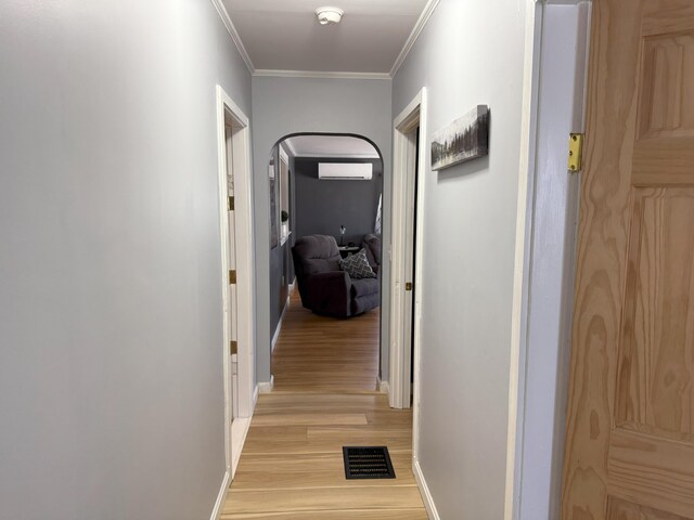 47 New Jersey St, Millinocket, ME 04462 - hall featuring a wall unit AC, light wood-style floors, crown molding, visible vents, and baseboards