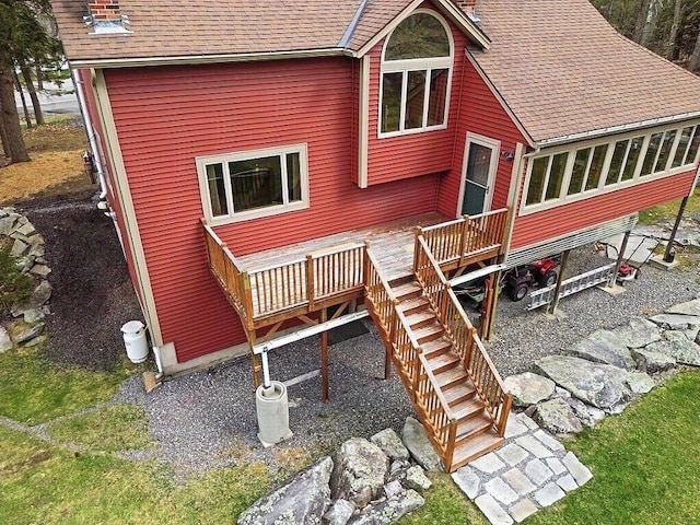 back of house with a shingled roof, stairs, and a wooden deck