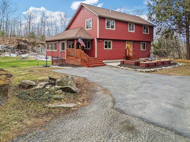 view of front of home with a shingled roof