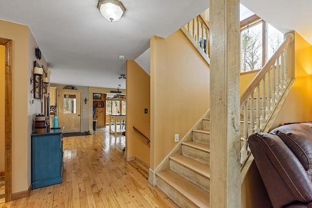 staircase with baseboards and hardwood / wood-style flooring