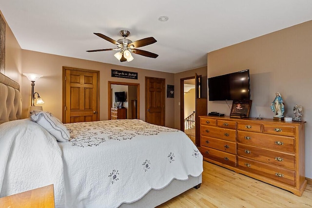 bedroom with light wood finished floors and ceiling fan