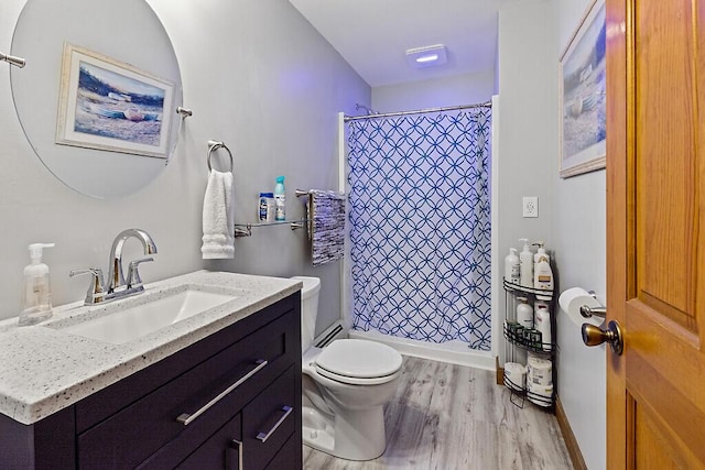 bathroom with vanity, a shower with shower curtain, wood finished floors, and toilet