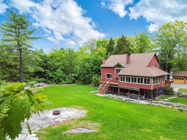 140 Old Belgrade Rd, Augusta, ME 04330 - back of property with stairway, a fire pit, a deck, a chimney, and a yard