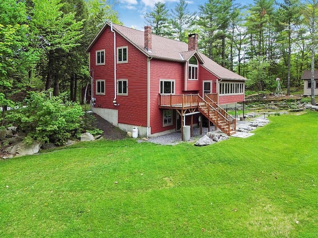140 Old Belgrade Rd, Augusta, ME 04330 - rear view of house with a chimney, a lawn, a wooden deck, and a sunroom