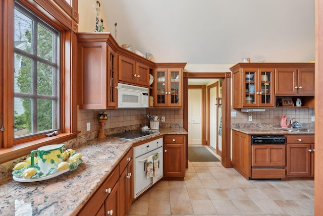 168 Ocean Ave, Kennebunkport, ME 04046 - kitchen with brown cabinets, light tile patterned flooring, white appliances, plenty of natural light, and backsplash