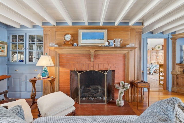 168 Ocean Ave, Kennebunkport, ME 04046 - living room with a fireplace, beamed ceiling, and wood finished floors