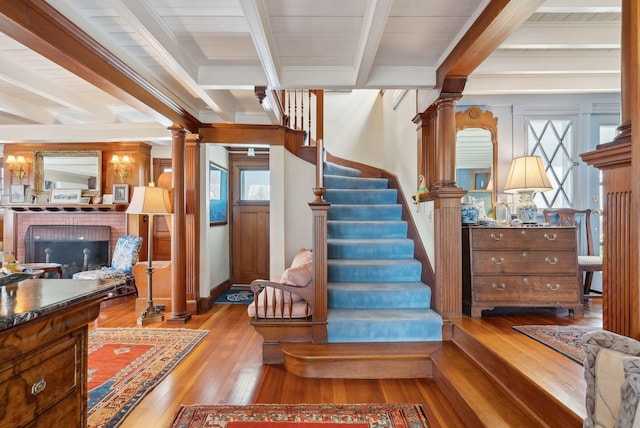 168 Ocean Ave, Kennebunkport, ME 04046 - stairway with crown molding, decorative columns, hardwood / wood-style flooring, and beam ceiling
