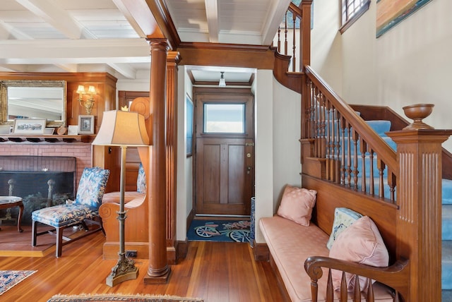 168 Ocean Ave, Kennebunkport, ME 04046 - foyer entrance featuring wood-type flooring, crown molding, decorative columns, beam ceiling, and stairway