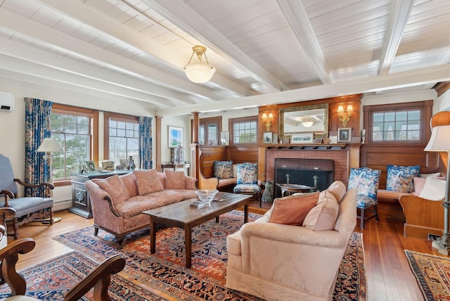 168 Ocean Ave, Kennebunkport, ME 04046 - living room with a baseboard radiator, a wall mounted AC, hardwood / wood-style flooring, and beamed ceiling