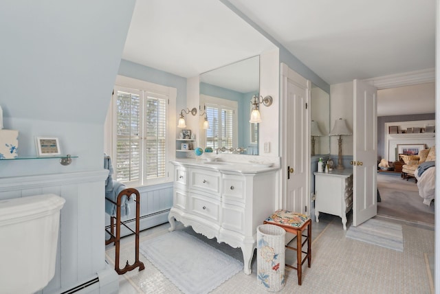 168 Ocean Ave, Kennebunkport, ME 04046 - ensuite bathroom with vanity, toilet, a wainscoted wall, ensuite bathroom, and a baseboard heating unit