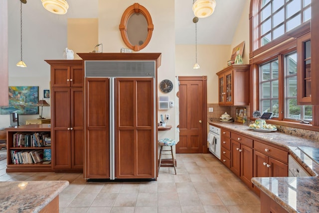 168 Ocean Ave, Kennebunkport, ME 04046 - kitchen with brown cabinets, high vaulted ceiling, light tile patterned floors, and paneled fridge