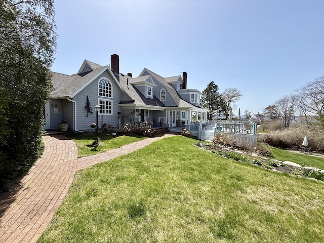 168 Ocean Ave, Kennebunkport, ME 04046 - view of front of property featuring a deck, a chimney, and a front lawn