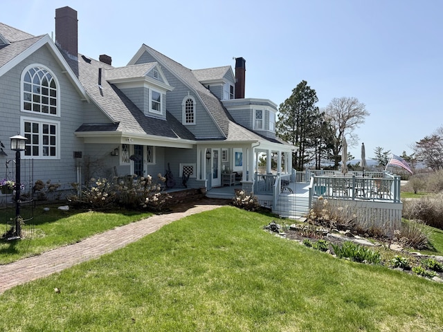 168 Ocean Ave, Kennebunkport, ME 04046 - back of property with a wooden deck, a shingled roof, a yard, and a chimney