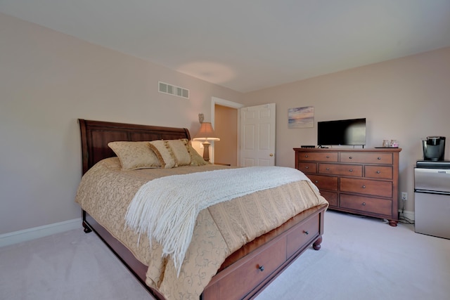 bedroom with baseboards, visible vents, and light carpet