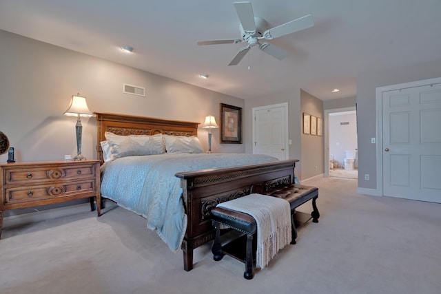bedroom with visible vents, baseboards, recessed lighting, light colored carpet, and ensuite bath
