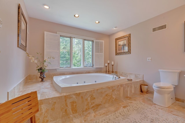 bathroom featuring toilet, marble finish floor, recessed lighting, a tub with jets, and visible vents