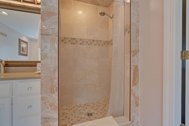 bathroom featuring recessed lighting, tiled shower, and vanity