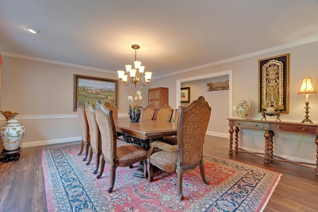 dining space featuring an inviting chandelier, baseboards, crown molding, and wood finished floors