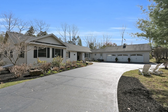 ranch-style house featuring an attached garage and driveway