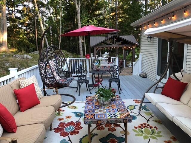 wooden terrace with an outdoor living space and a gazebo