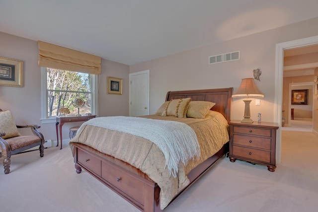 bedroom featuring light carpet and visible vents