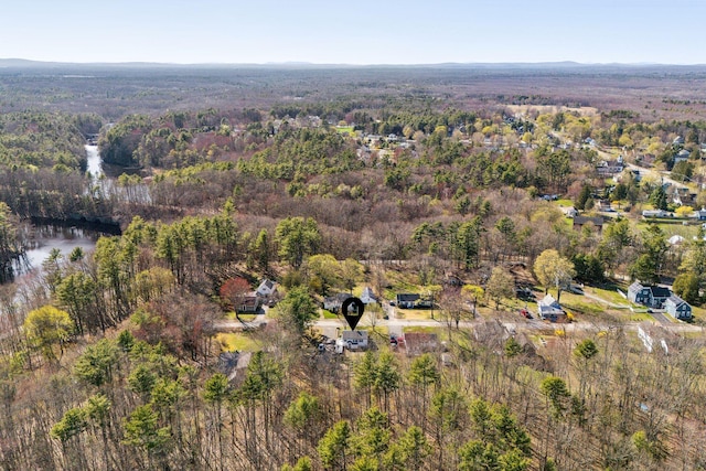 birds eye view of property with a view of trees
