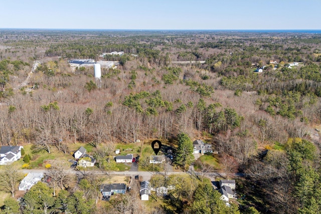 birds eye view of property featuring a wooded view