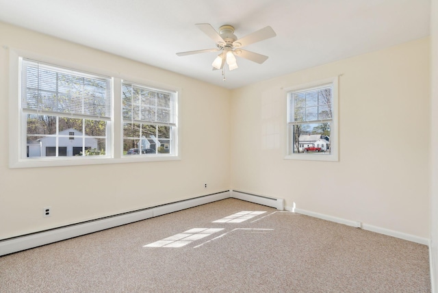 carpeted empty room featuring baseboards, ceiling fan, a wealth of natural light, and baseboard heating