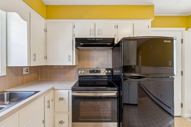 kitchen with light countertops, appliances with stainless steel finishes, under cabinet range hood, and white cabinets