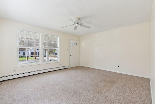 spare room featuring a ceiling fan, baseboards, baseboard heating, and carpet flooring