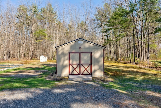 view of shed with a wooded view