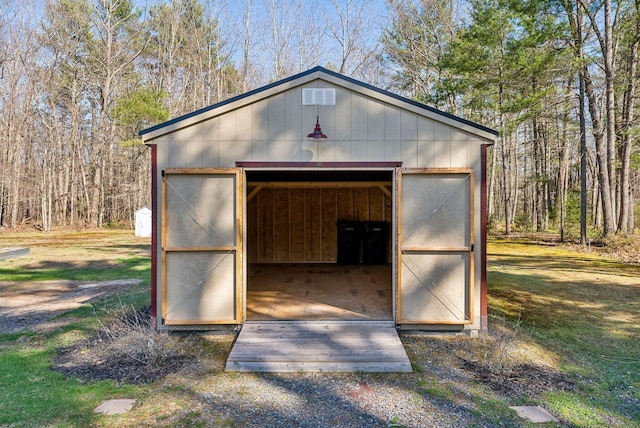 view of outbuilding with a view of trees and an outbuilding